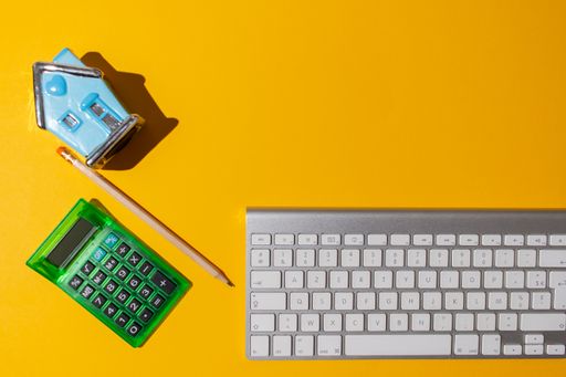 A top view of a bright orange surface with miscellaneous objects placed on it
