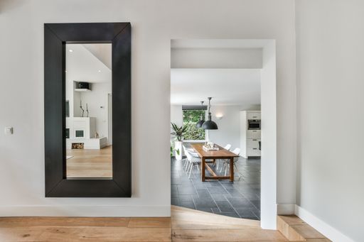 A modern room with different furniture and the bright light coming from the window