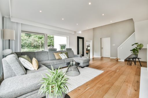 A modern room with different furniture and the bright light coming from the window