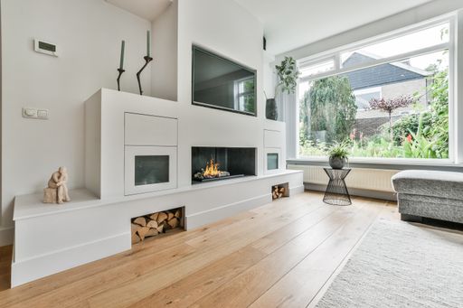 A kitchen with the furniture in it and the bright light coming from the window
