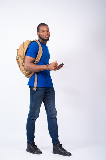 A black student using his phone and doing a thumbs up