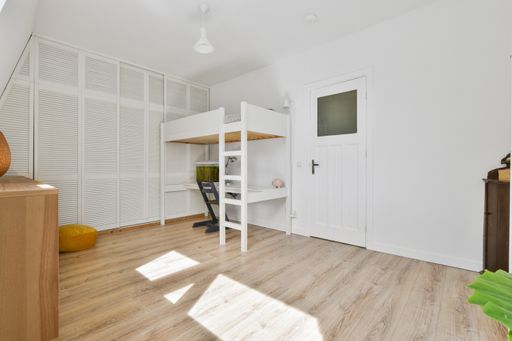 A modern room with different furniture and the bright light coming from the window