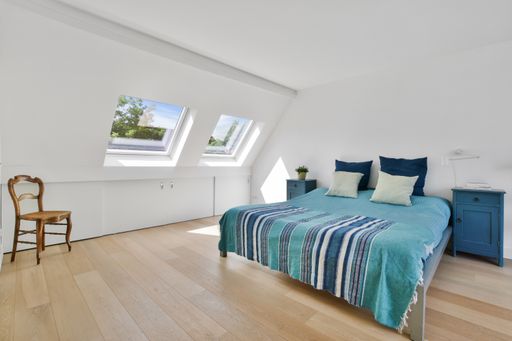 A modern room with different furniture and the bright light coming from the window
