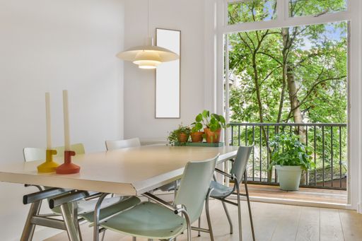 A modern room with different furniture and the bright light coming from the window