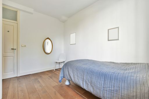 A modern room with different furniture and the bright light coming from the window