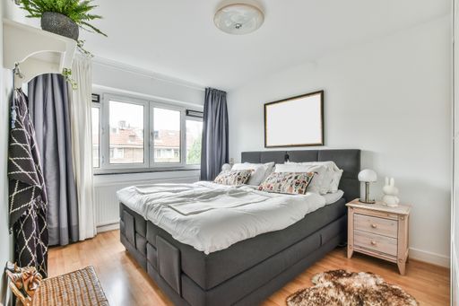 A modern room with different furniture and the bright light coming from the window