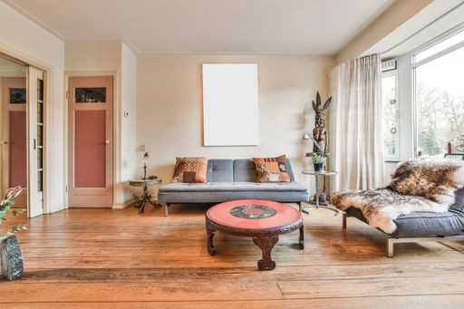 A modern room with different furniture and the bright light coming from the window