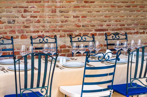 A festive table setting with empty wine glasses and white plates. Table setting for special events