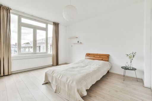 A modern room with furniture and the bright light coming from the window