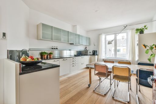 A modern room with furniture and the bright light coming from the window