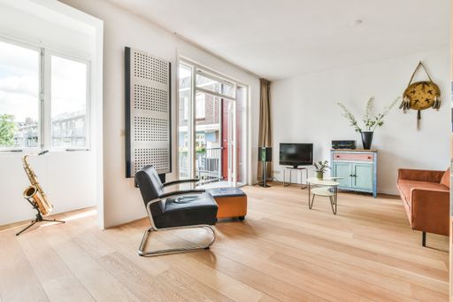 A modern room with furniture and the bright light coming from the window