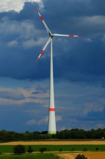 Wind turbine against a stormy sky in Hesse, Germany. Energy generation in an agricultural landscape.
