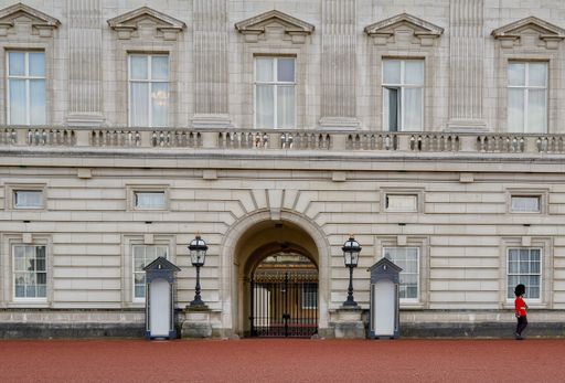 Queen's guards in red uniforms during the Changing of the Guard ceremony at Buckingham Palace, London.