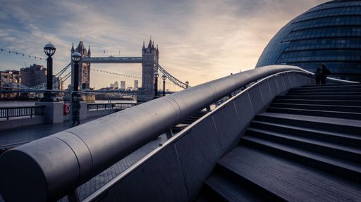 Ambient purple hues at London Bridge as the Thames sidewalks awaken.