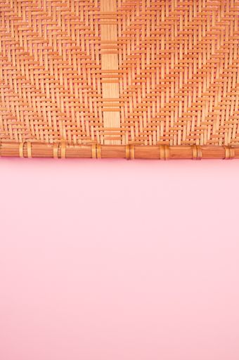 A vertical shot of bamboo wicker tray isolated on gray background