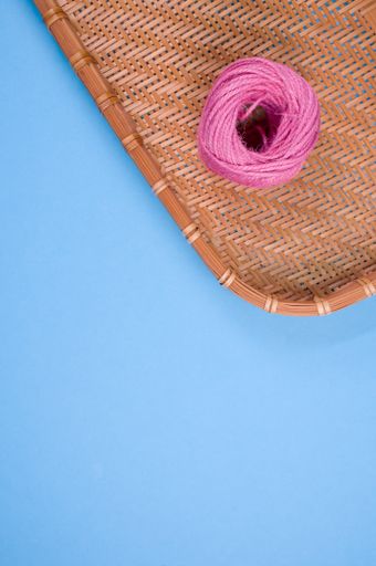 A vertical shot of a delicious donut on a woven fabric on a blue surface