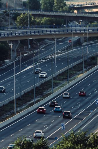 A vertical shot of cars on intersecting highways in Madrid, Spain