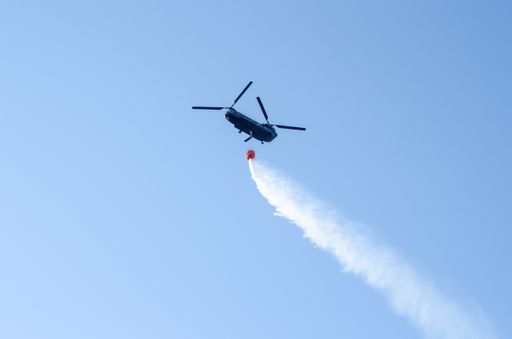 A low-angle shot of a jet firefighting aircraft putting out the wildfires of Greece