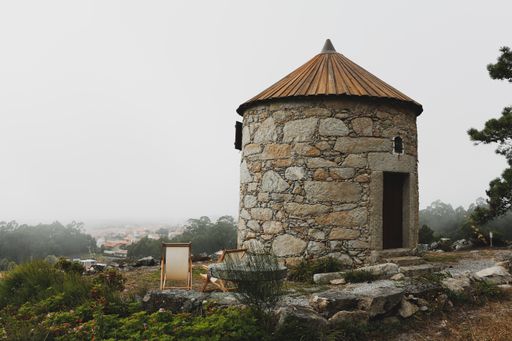 A scenic view of a stone house in farmland in the countryside