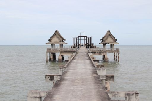 A jetty or pier made of steel concrete, which leads to a deserted place right by the sea in Thailand Southeast Asia