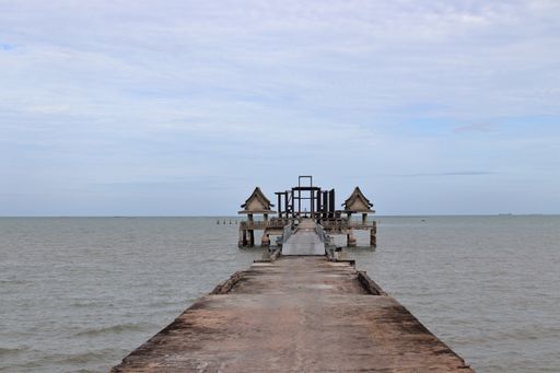 A jetty or pier made of steel concrete, which leads to a deserted place right by the sea in Thailand Southeast Asi