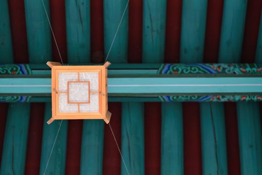A low angle shot of an ornament hanging from a ceiling of a castle in South Korea
