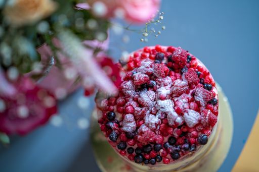 A closeup of raspberry cake covered by sugar powder