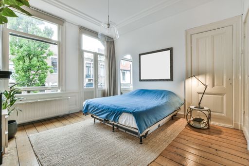 A modern room with furniture and the bright light coming from the window