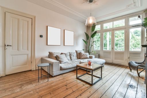 A modern room with furniture and the bright light coming from the window