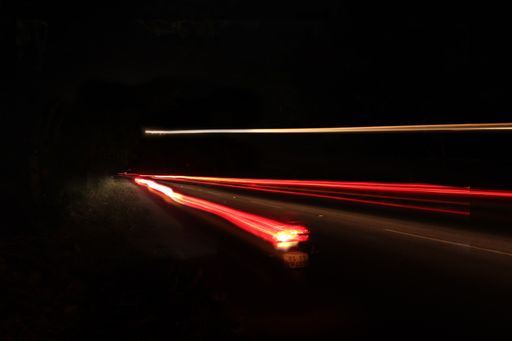 A time-lapse shot of the red car lights in motion on the highway at night
