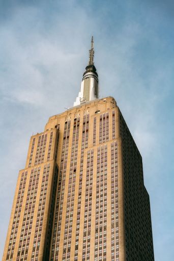 The Empire State Building stands tall against a clear blue sky in New York City.