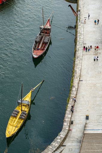 A beautiful view of the boats in the harbor near the water on a sunyn day