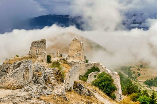 The remains of a building surrounded by the mist descended from the mountains