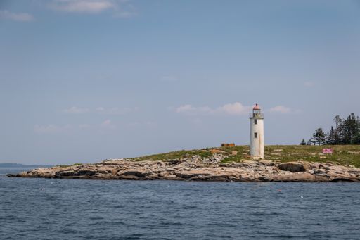 A landscape of a sea with a lighthouse in Maine