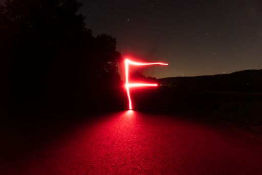 A shot of red light abstract symbol in the night made with long exposure