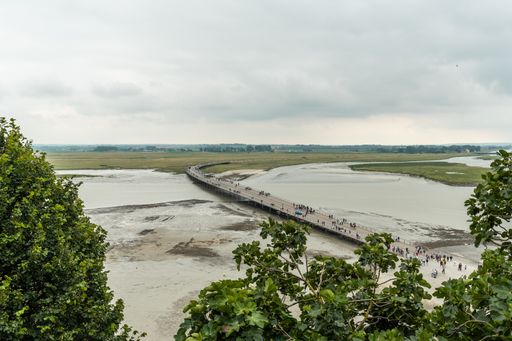 The arrival trail to the famous Mont Saint-Michel Abbey at high tide in the Manche department