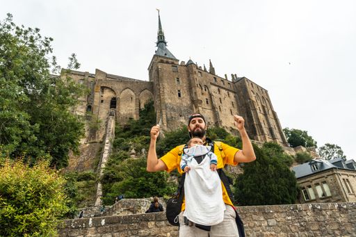 A young father and his baby visiting the Mont Saint-Michel Abbey in the Normandy region of France