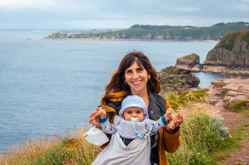 A closeup shot of a young mother and her adorable child posing near the shore in Plevenon, France