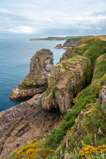 A vertical shot of the coastline next to the Phare Du Cap Frehel lighthouse in Cotes-d'Armor, France