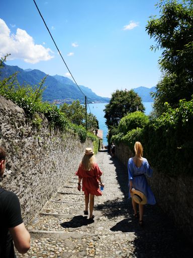 A rear shot of young women going to the lake through narrow street