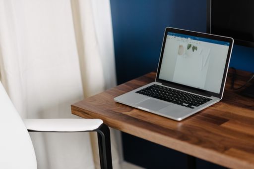A closeup shot of a laptop on a wooden desk