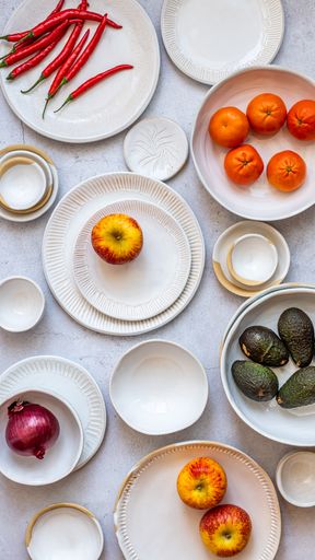 Table Setting of white ceramics with vegetables and fruit