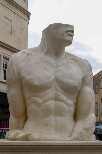 A vertical shot of the famous English swimmer Mark Foster's sculpture in Bath, the United Kingdom