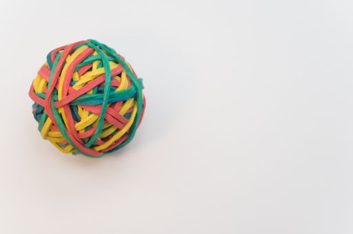 A closeup shot of a colorful rubber band ball isolated on white background