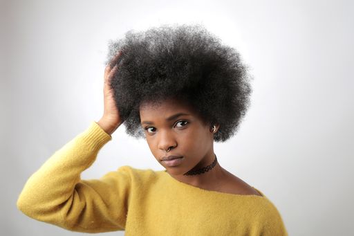 A young beautiful African American female with an afro posing