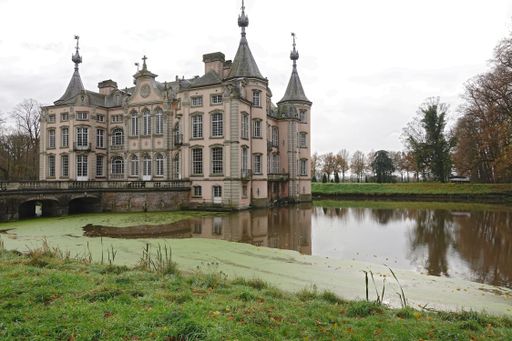 Poeke Flanders Belgium 11 26 2024 A picturesque castle with pointed towers surrounded by a moat and autumn foliage.