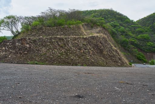 Very tight curve where vehicles pass with great caution and surrounds a mountain