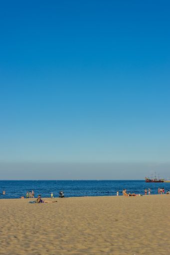 A vertical shot of a sunny sandy beach during daytime in Sopot, Poland