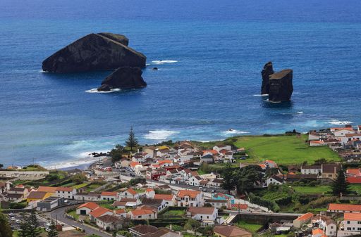 Scenic view of Vila Franca do Campo, Azores, with rocky islets in the Atlantic Ocean and charming coastal village in the foreground.