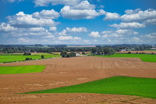 A mesmerizing landscape view with green areas against a blue cloudy sky